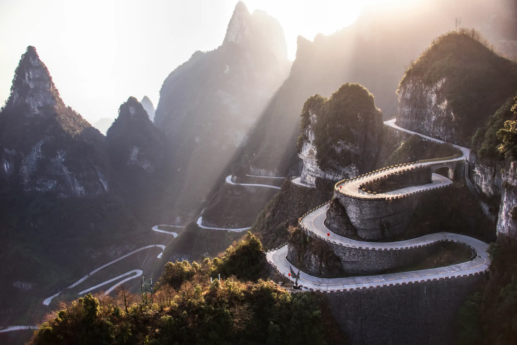 The winding Tianmen Mountain road in late light