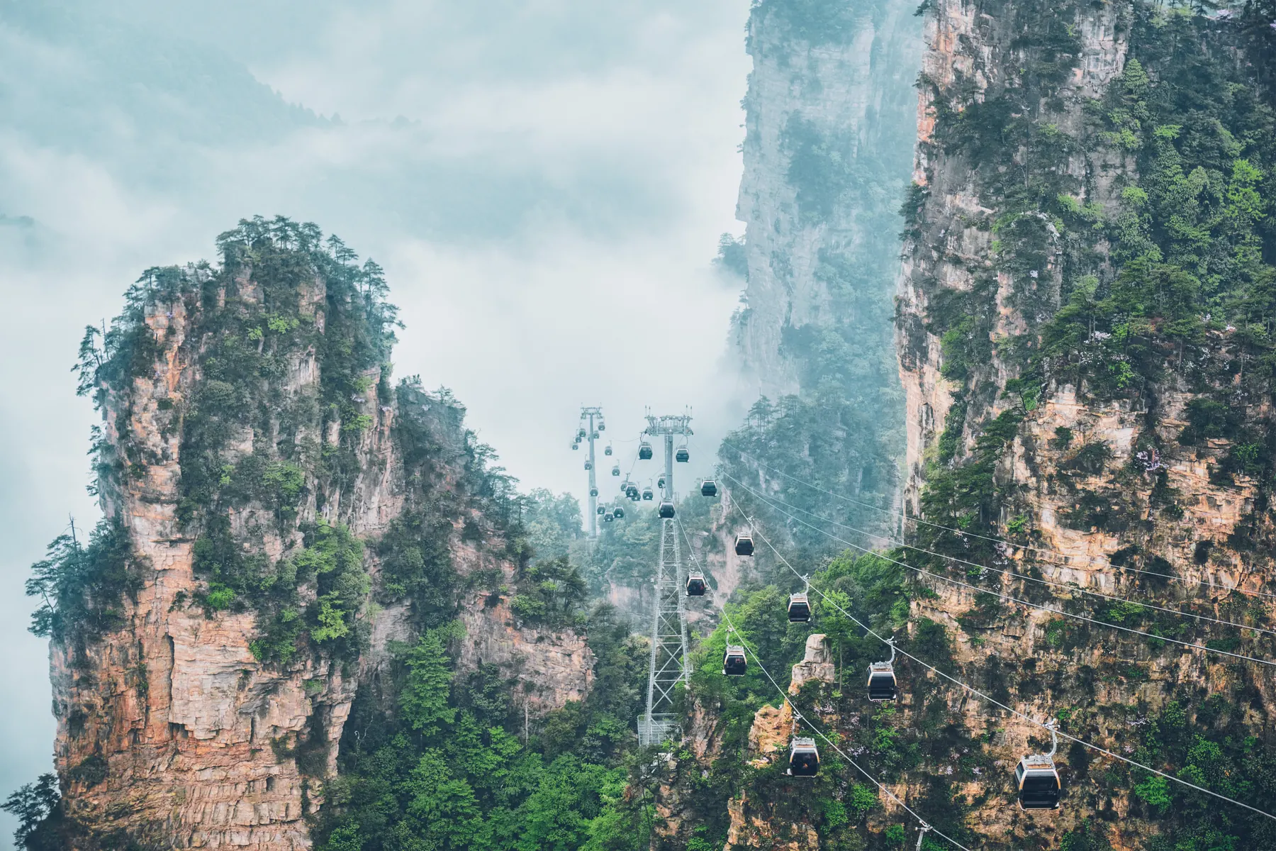 Cable car gliding between quartzite pillars, National Forest Park